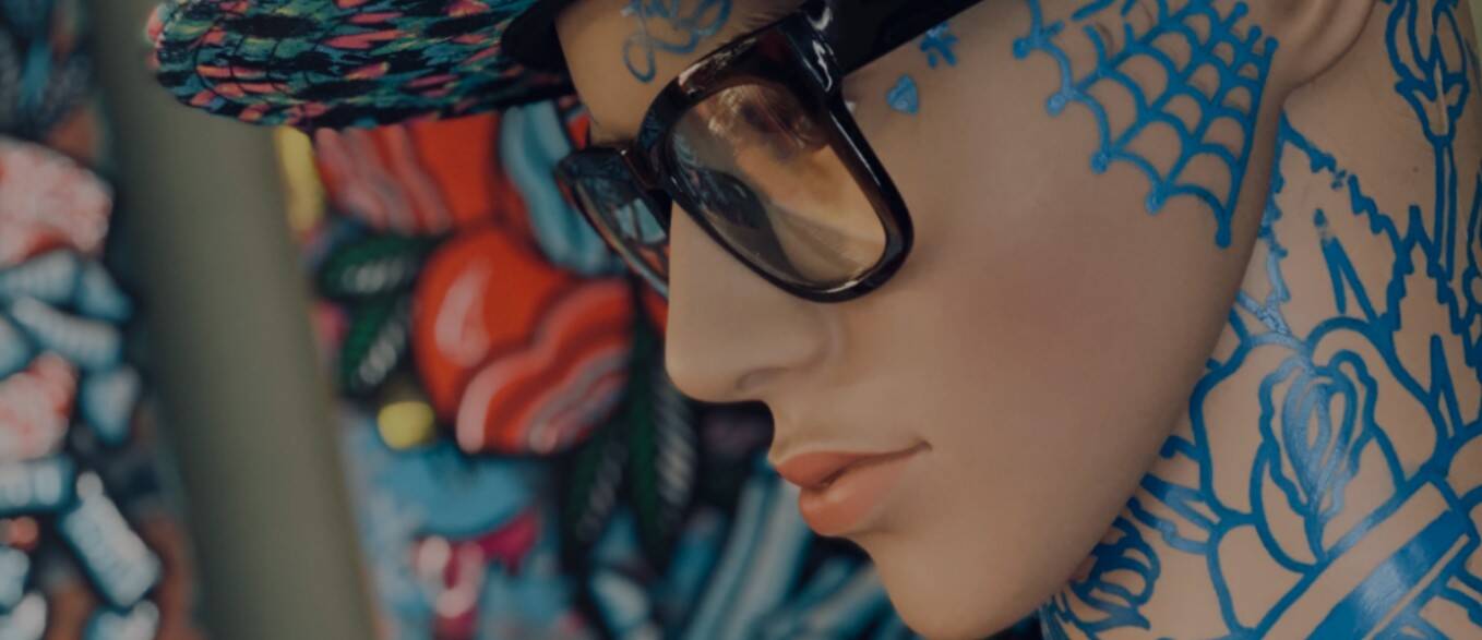 Tattooed mannequin with sunglasses — Loyalty's signature style